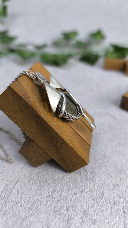 Dragon carrying an authentic roman coin