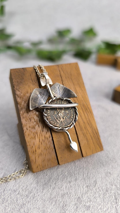 Dragon carrying an authentic roman coin