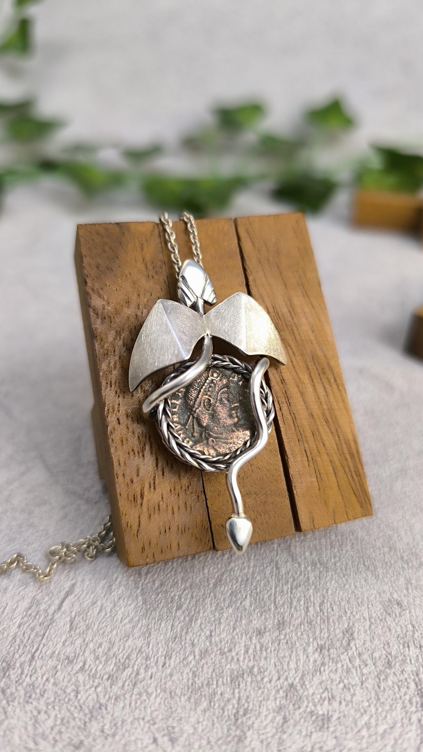 Dragon carrying an authentic roman coin