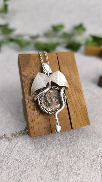Dragon carrying an authentic roman coin