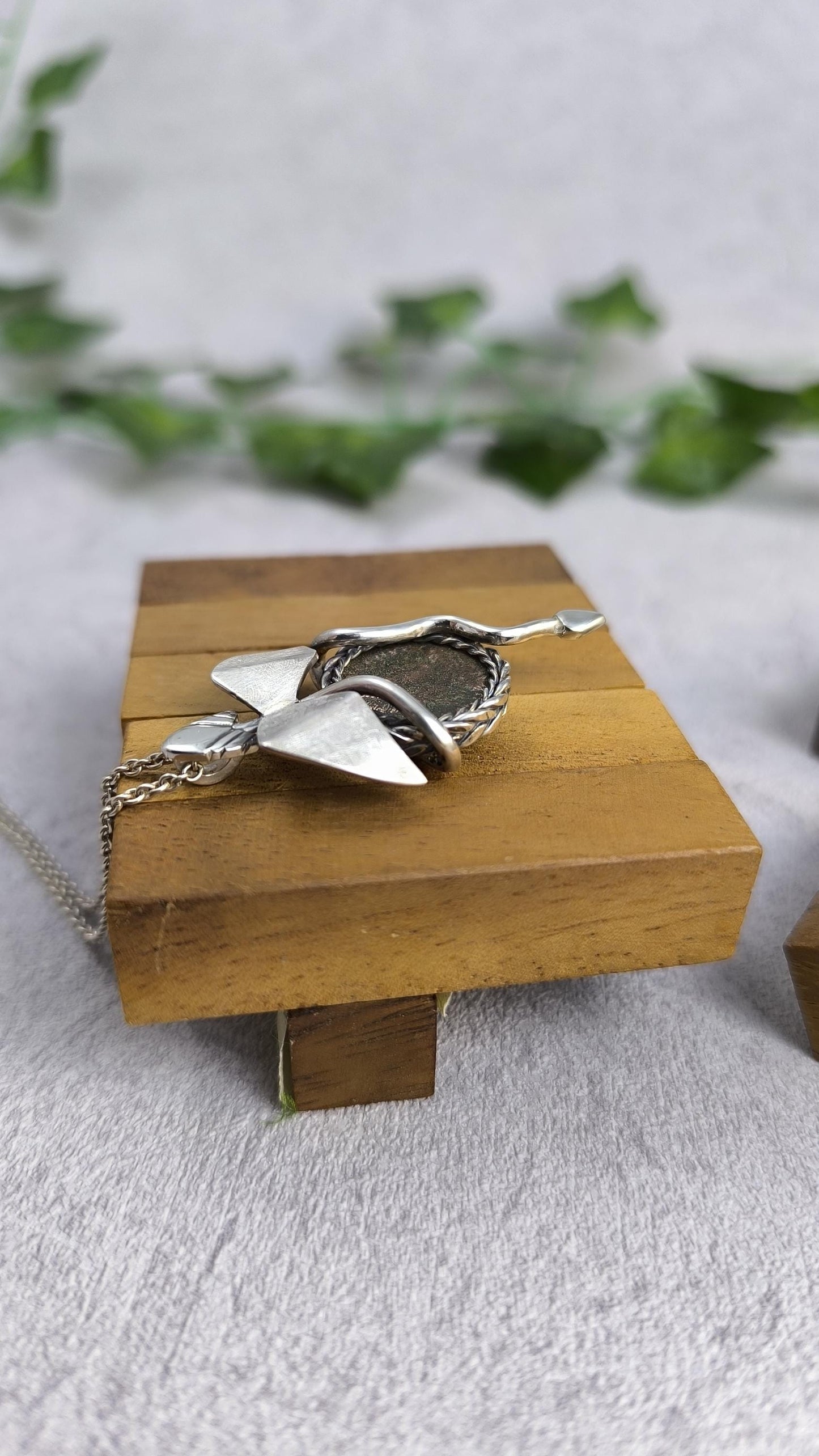 Dragon carrying an authentic roman coin