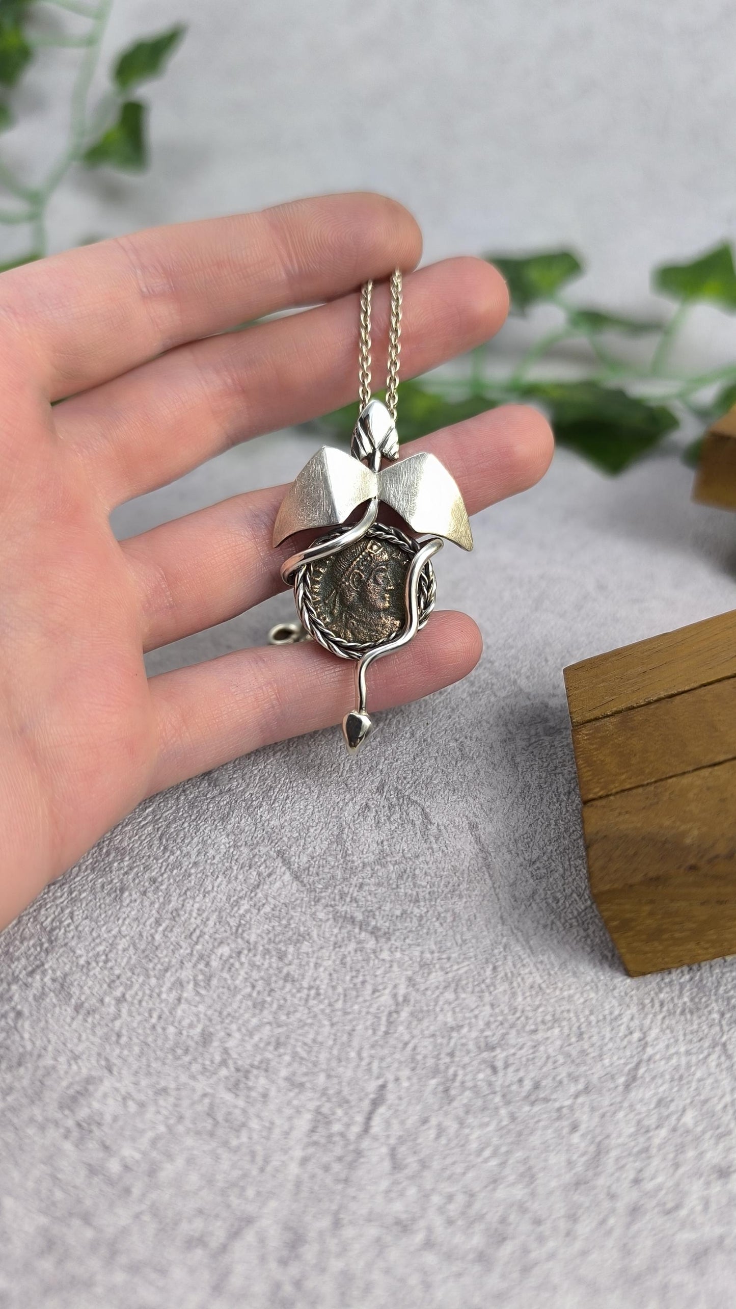 Dragon carrying an authentic roman coin